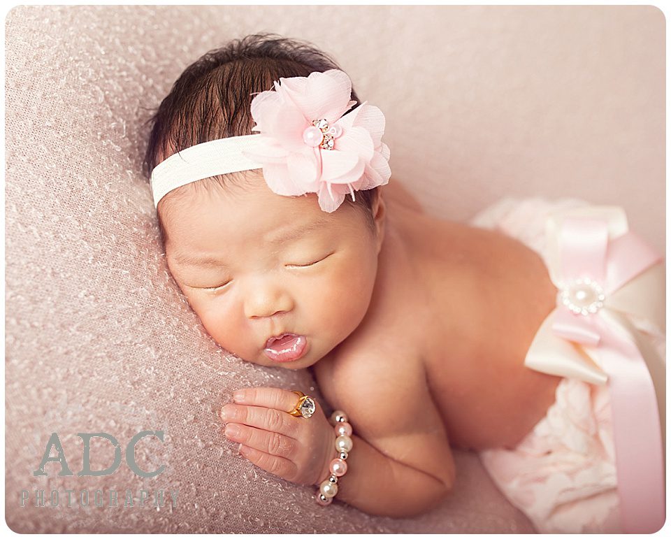 Newborn baby girl portrait in pink