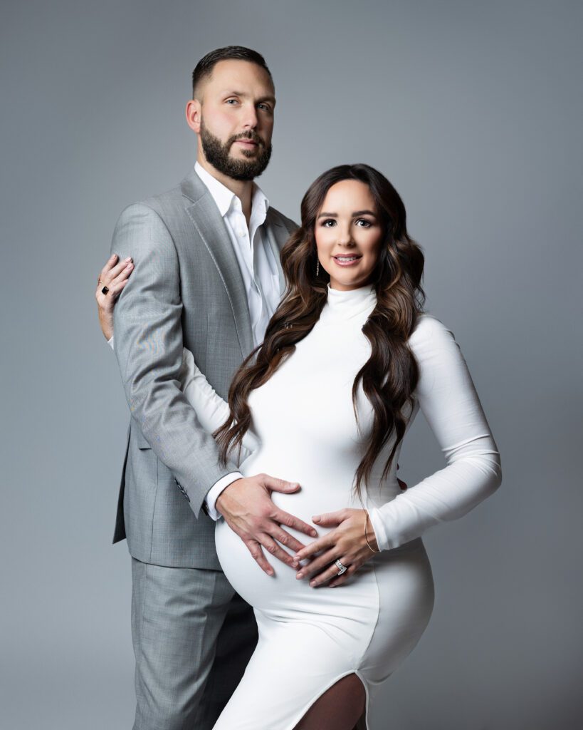 Romantic maternity portrait of expectant parents in the studio