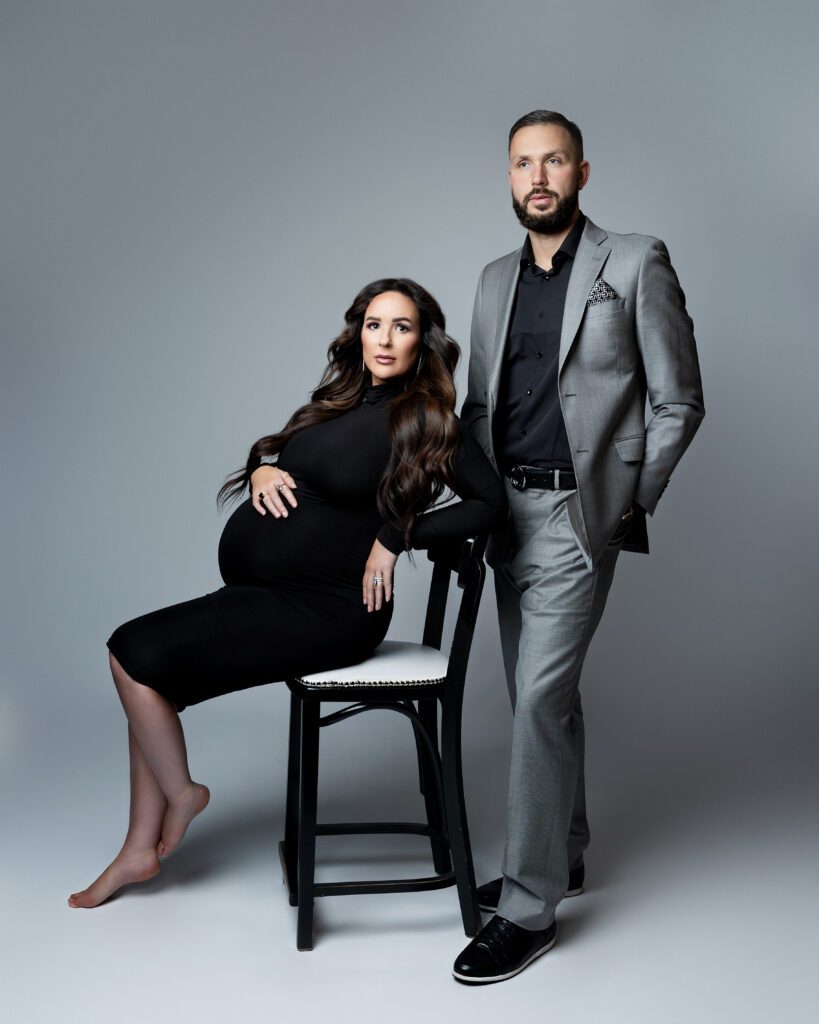 Luxury studio maternity portrait of expectant mother and husband
