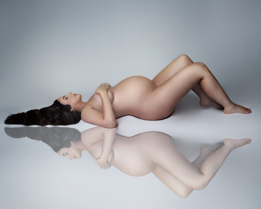 Fine art reclining maternity portrait with reflection