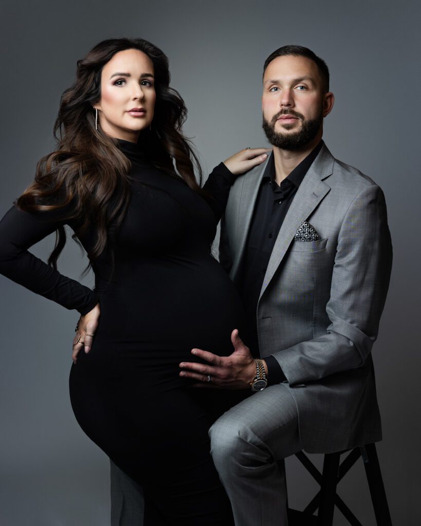 Editorial maternity portrait of expectant parents in black and gray