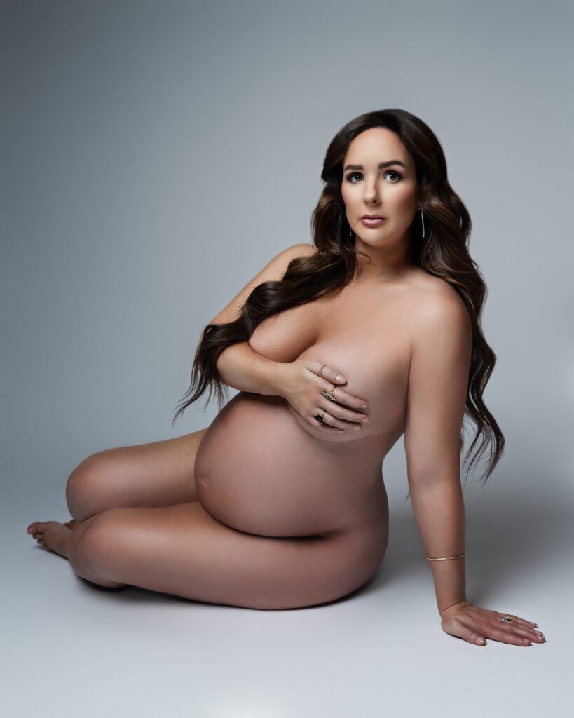 Tasteful maternity boudoir portrait photographed in a studio