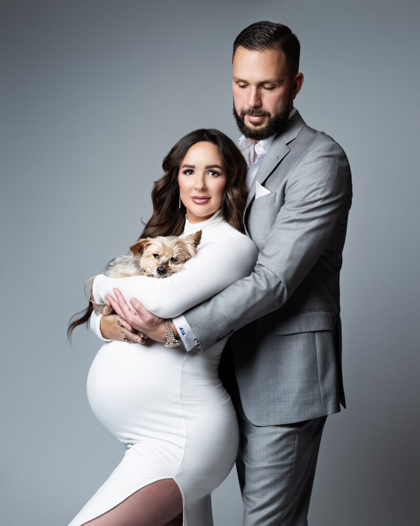 Expectant couple including their small dog in their maternity portraits
